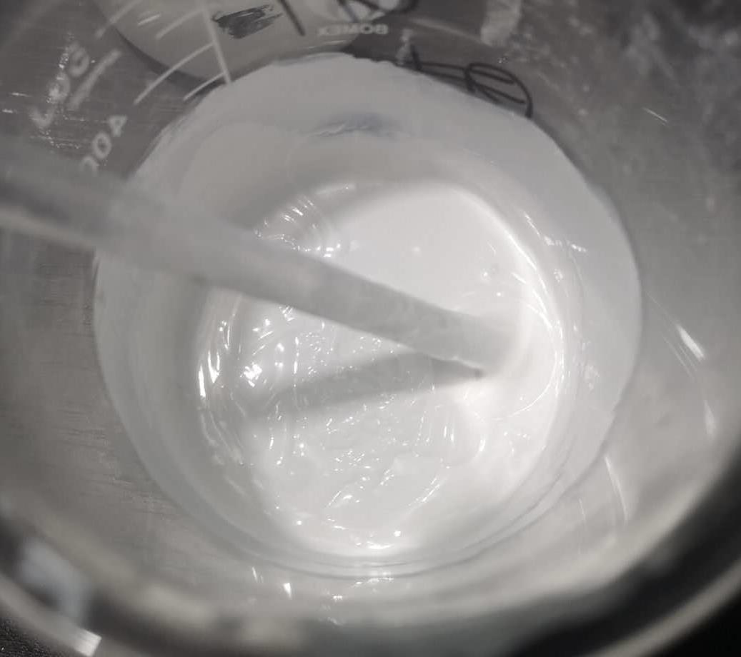 White thermal filler slurry being mixed in a beaker